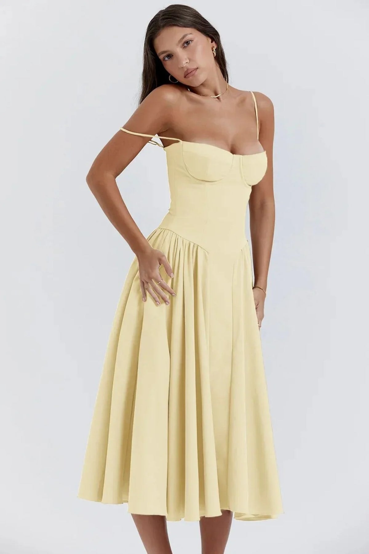 Woman in strapless midi dress with corset bodice and flowy skirt.