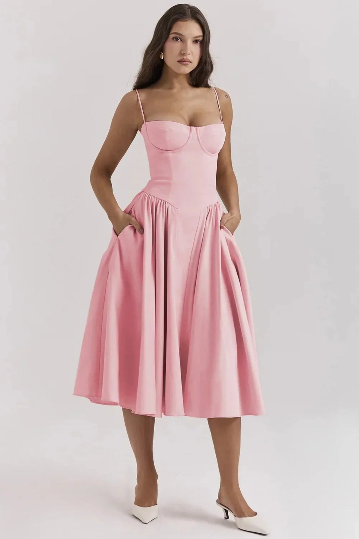 Woman in strapless midi dress with corset bodice and flowy skirt.