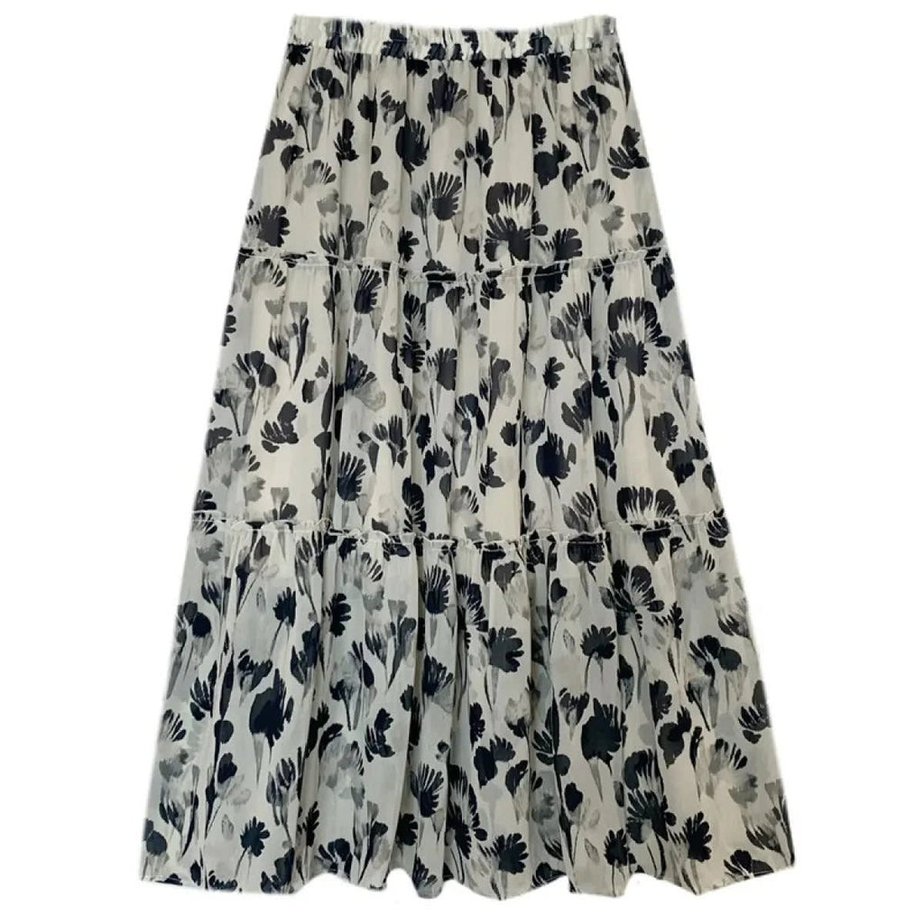 Woman in tiered maxi dress with floral print and cardigan.