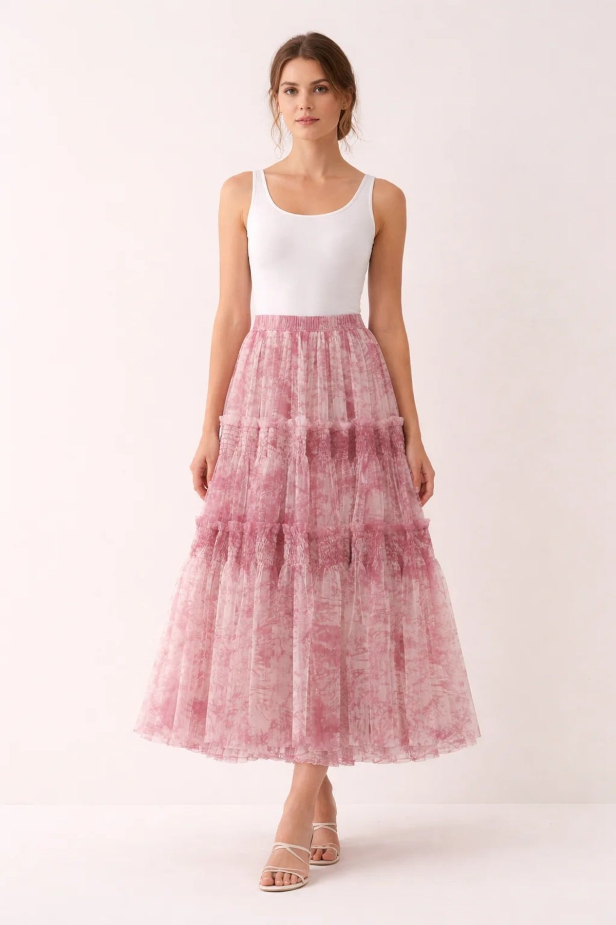 Woman in high-waisted tiered maxi skirt with abstract print.