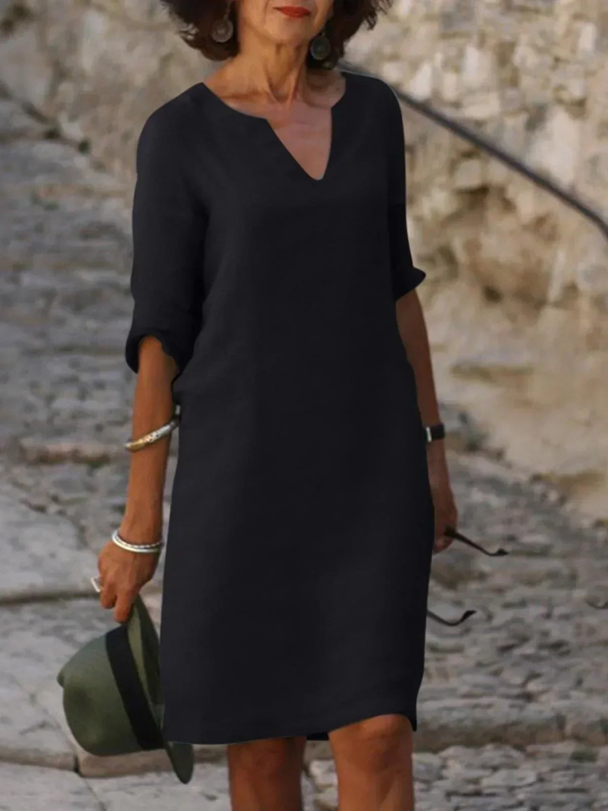 A dress with V-neck and pleated details, layered design.