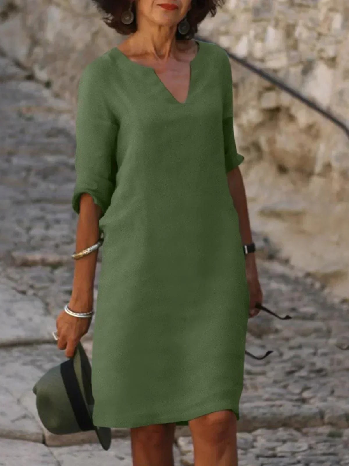 A dress with V-neck and pleated details, layered design.