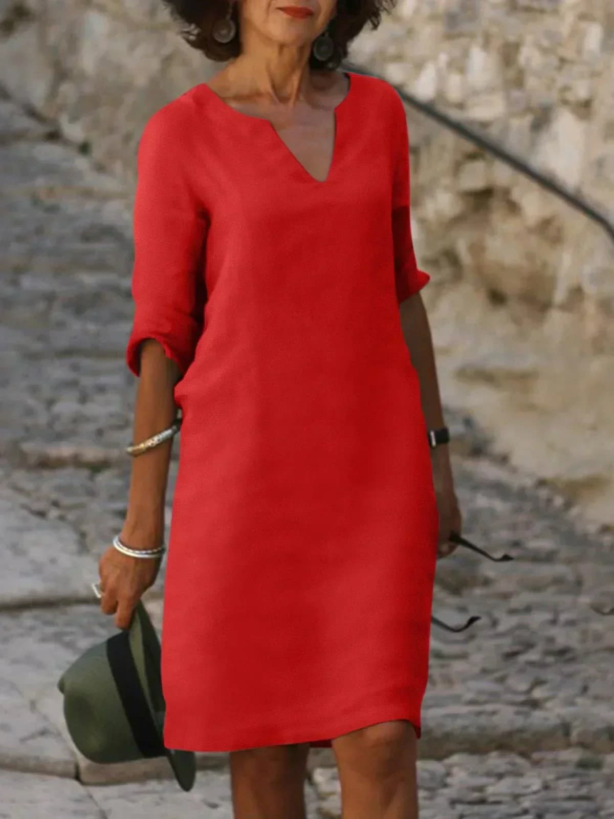 A dress with V-neck and pleated details, layered design.