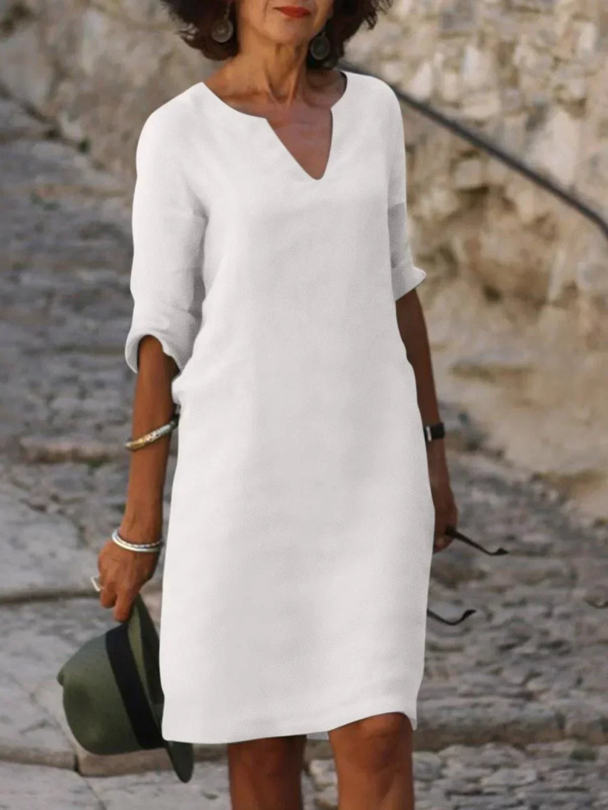 A dress with V-neck and pleated details, layered design.