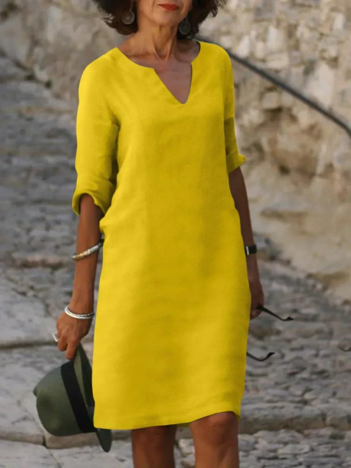 A dress with V-neck and pleated details, layered design.