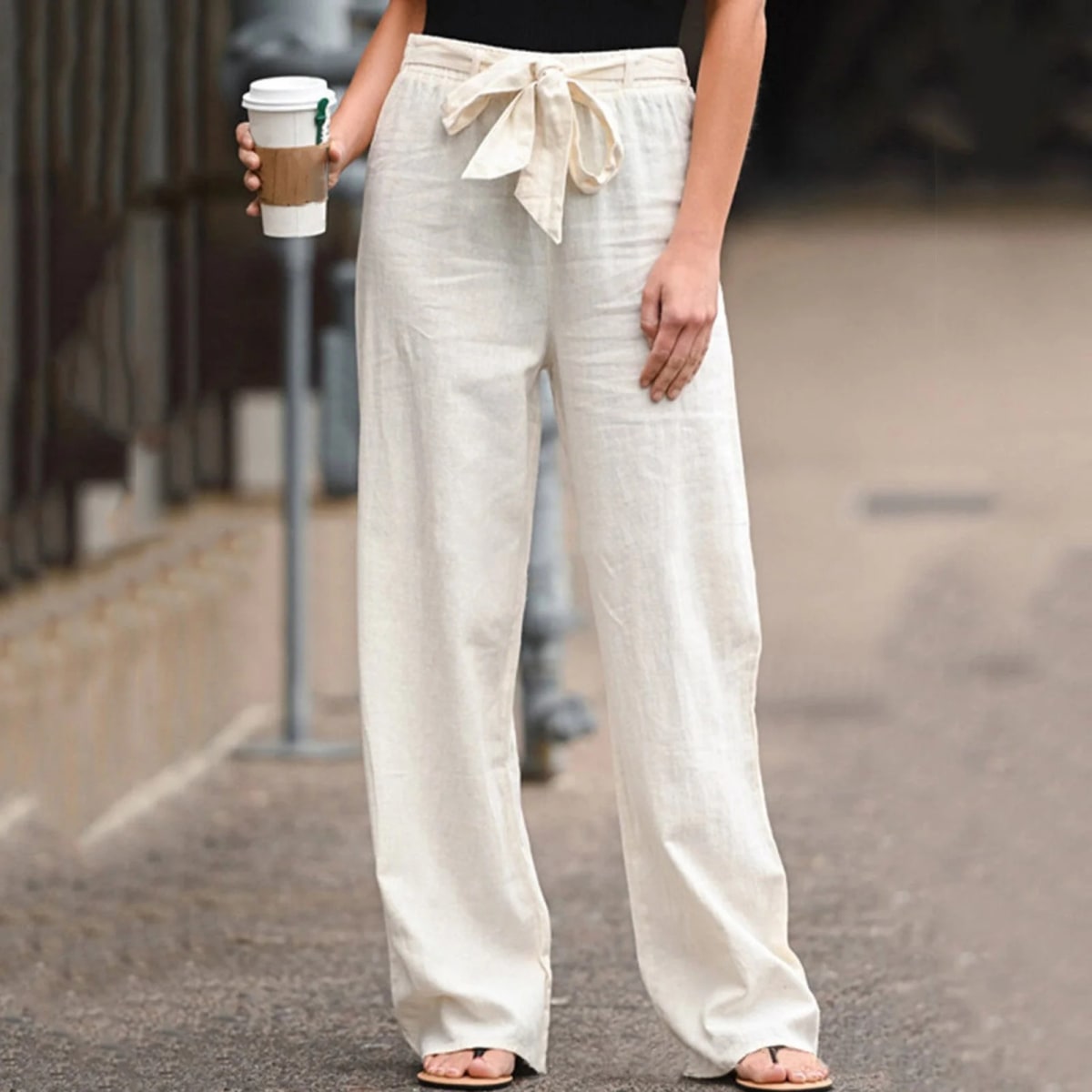 Wide-leg pants with drawstring waist and linen texture.