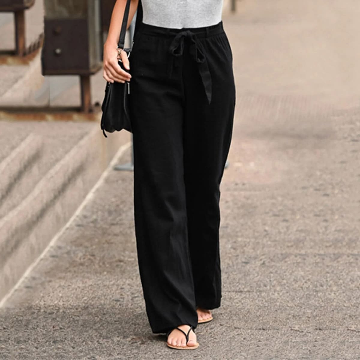 Wide-leg pants with drawstring waist and linen texture.