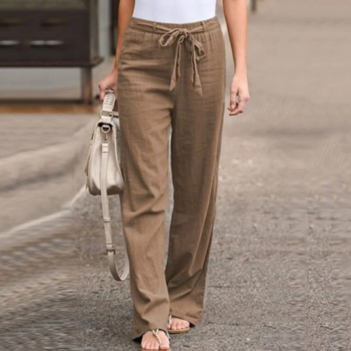 Wide-leg pants with drawstring waist and linen texture.