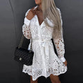 Lace mini dress with long sleeves and belted waist.
