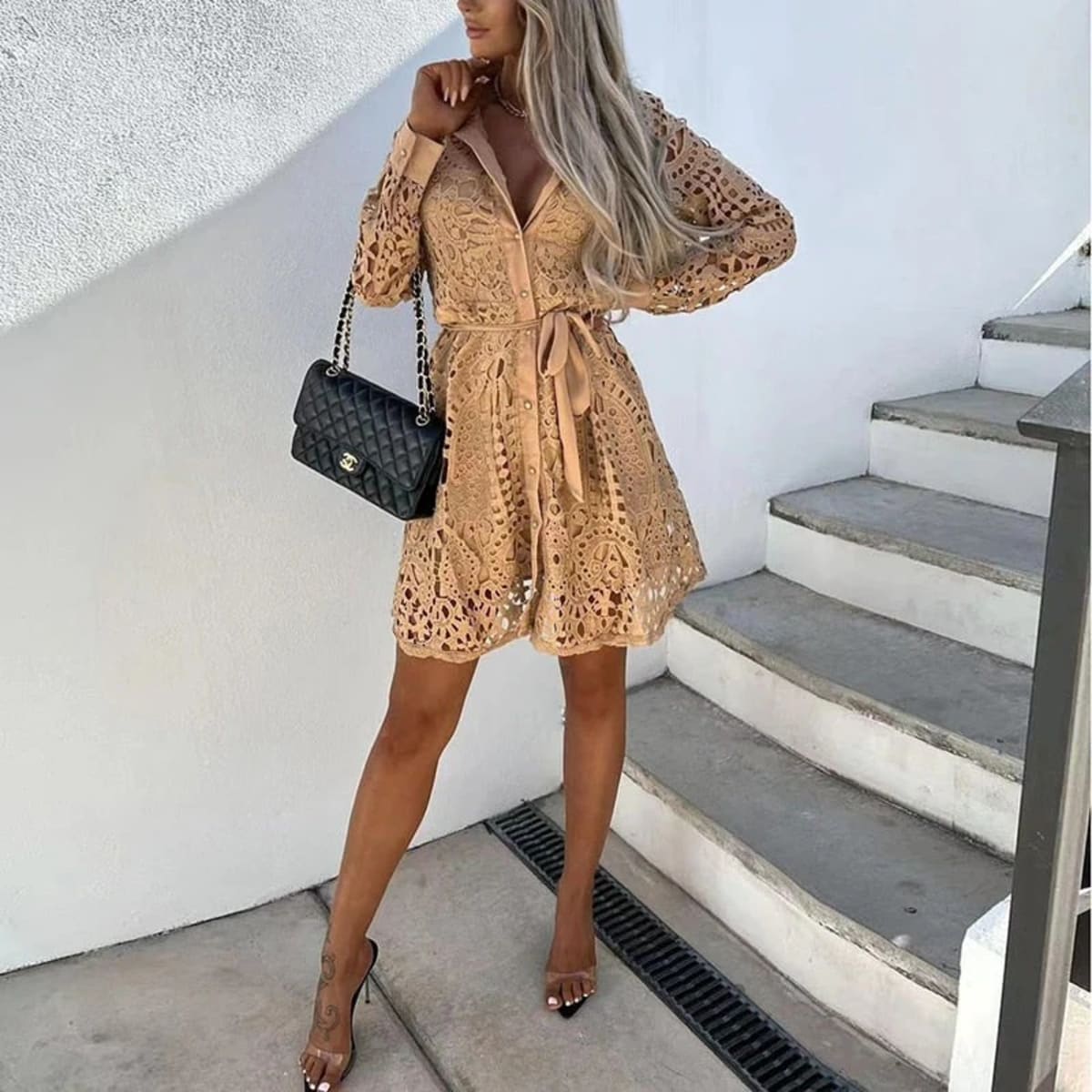 Lace mini dress with long sleeves and belted waist.