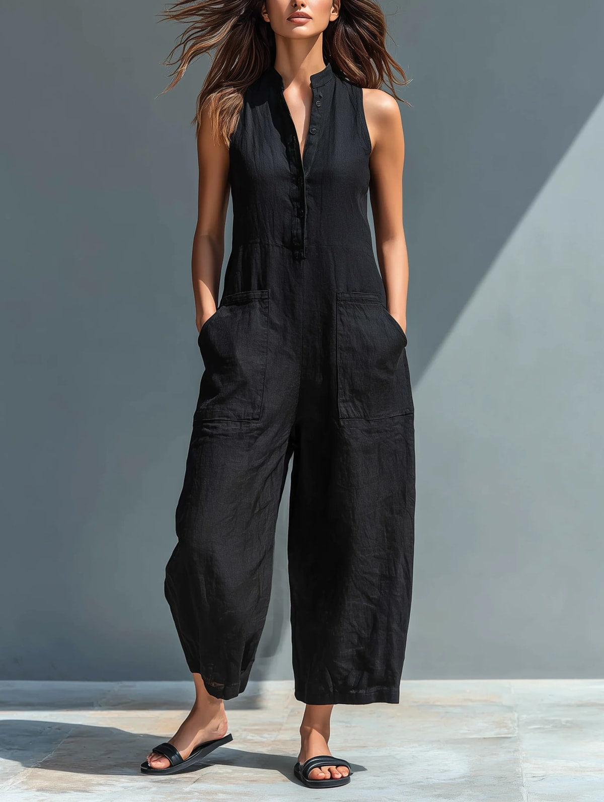 Sleeveless jumpsuit with mandarin collar and wide-leg pants.