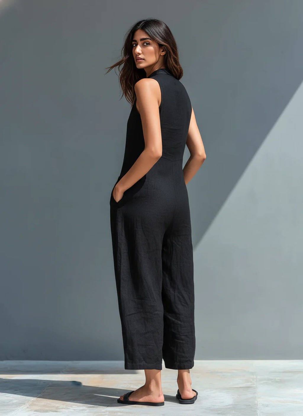 Sleeveless jumpsuit with mandarin collar and wide-leg pants.