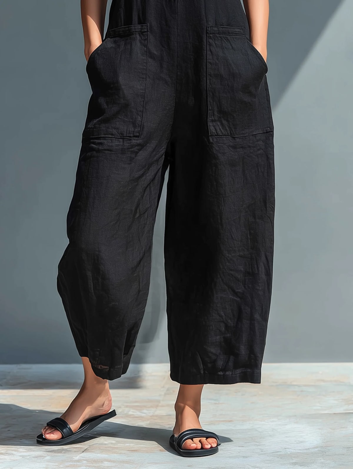 Sleeveless jumpsuit with mandarin collar and wide-leg pants.