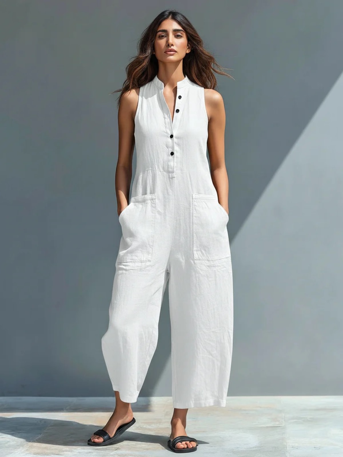 Sleeveless jumpsuit with mandarin collar and wide-leg pants.