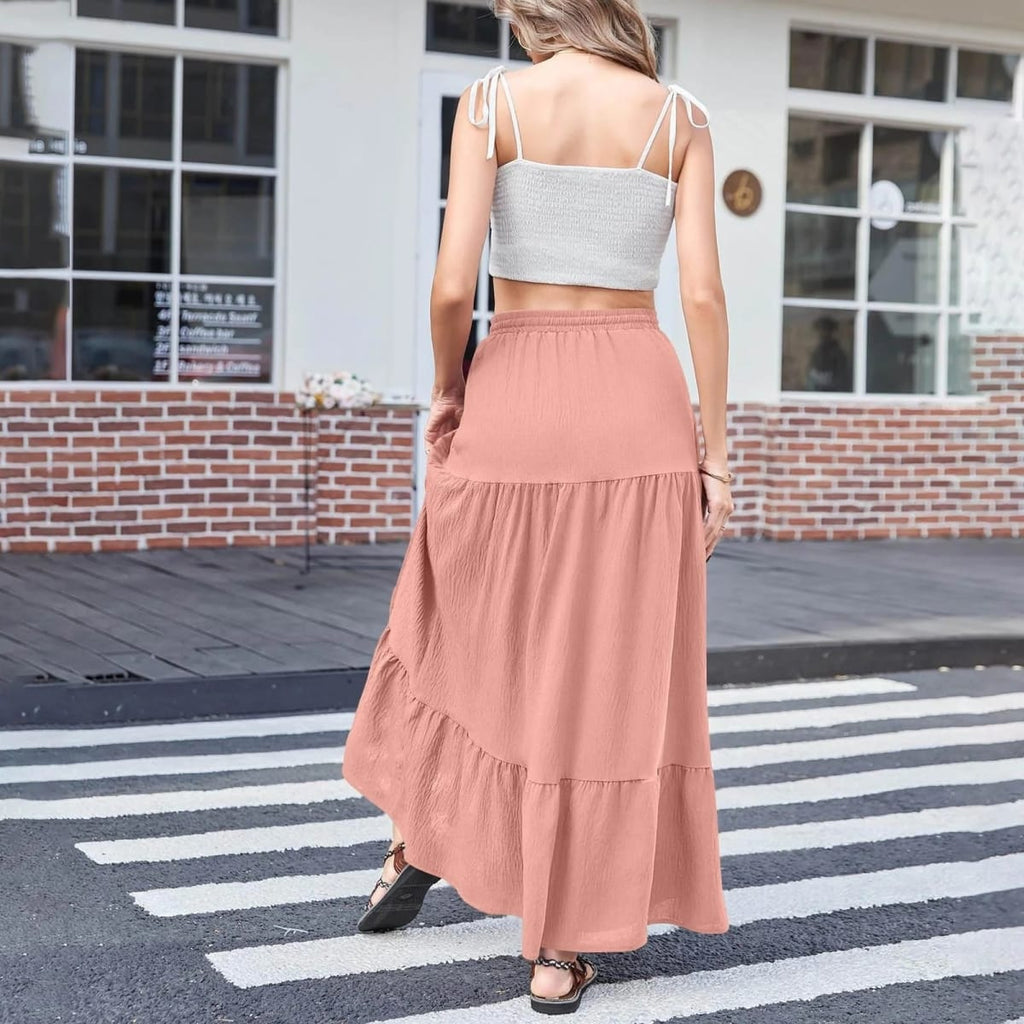 Woman wearing a tiered maxi skirt with a side slit and crop top.