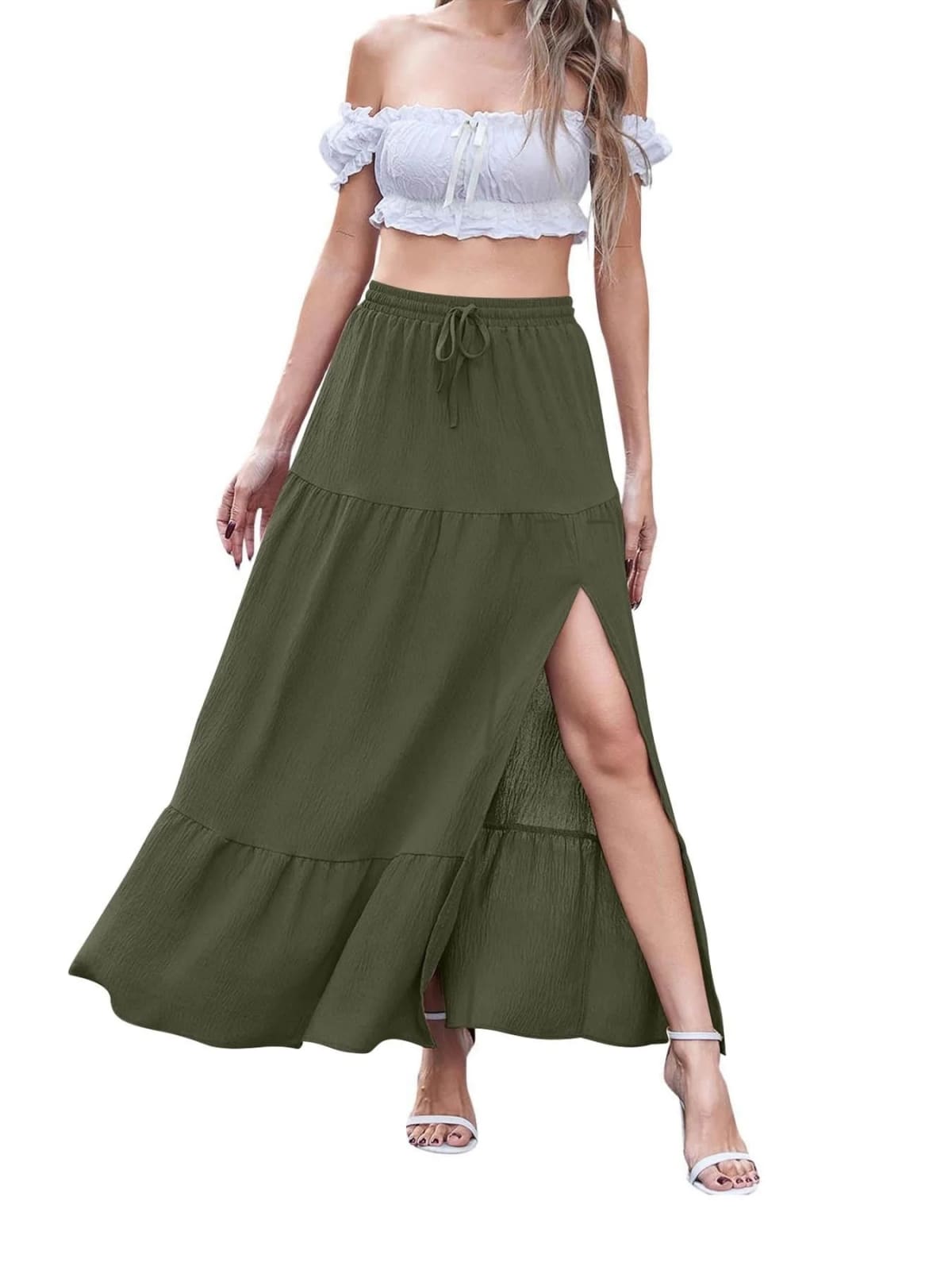 Woman wearing a tiered maxi skirt with a side slit and crop top.