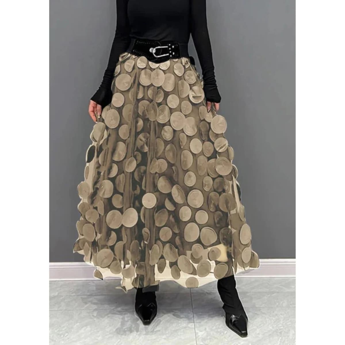 Woman wearing a voluminous appliqued mesh maxi skirt.