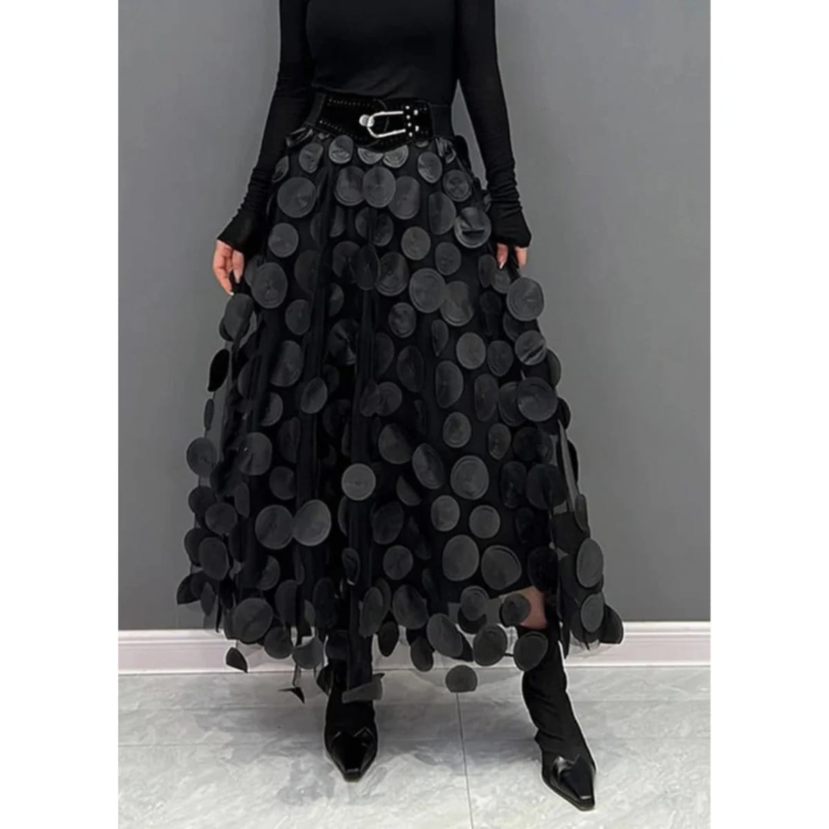 Woman wearing a voluminous appliqued mesh maxi skirt.