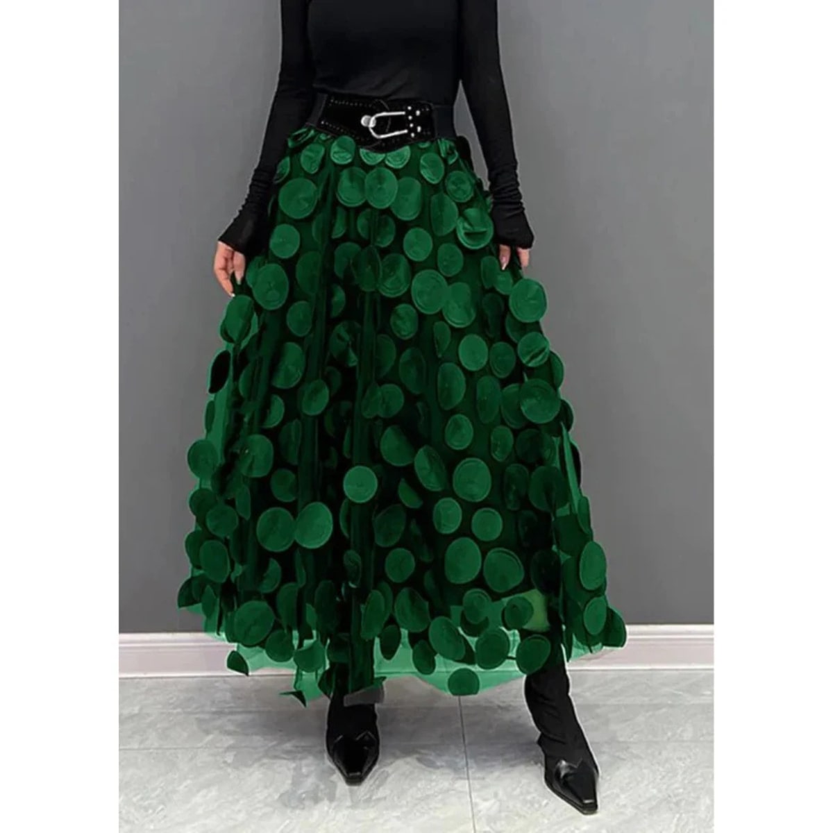 Woman wearing a voluminous appliqued mesh maxi skirt.