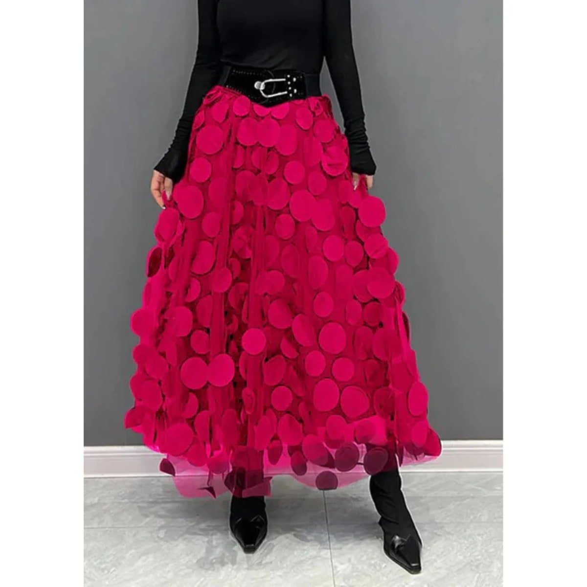 Woman wearing a voluminous appliqued mesh maxi skirt.
