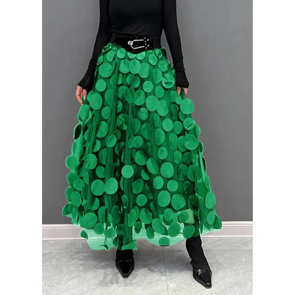 Woman wearing a voluminous appliqued mesh maxi skirt.