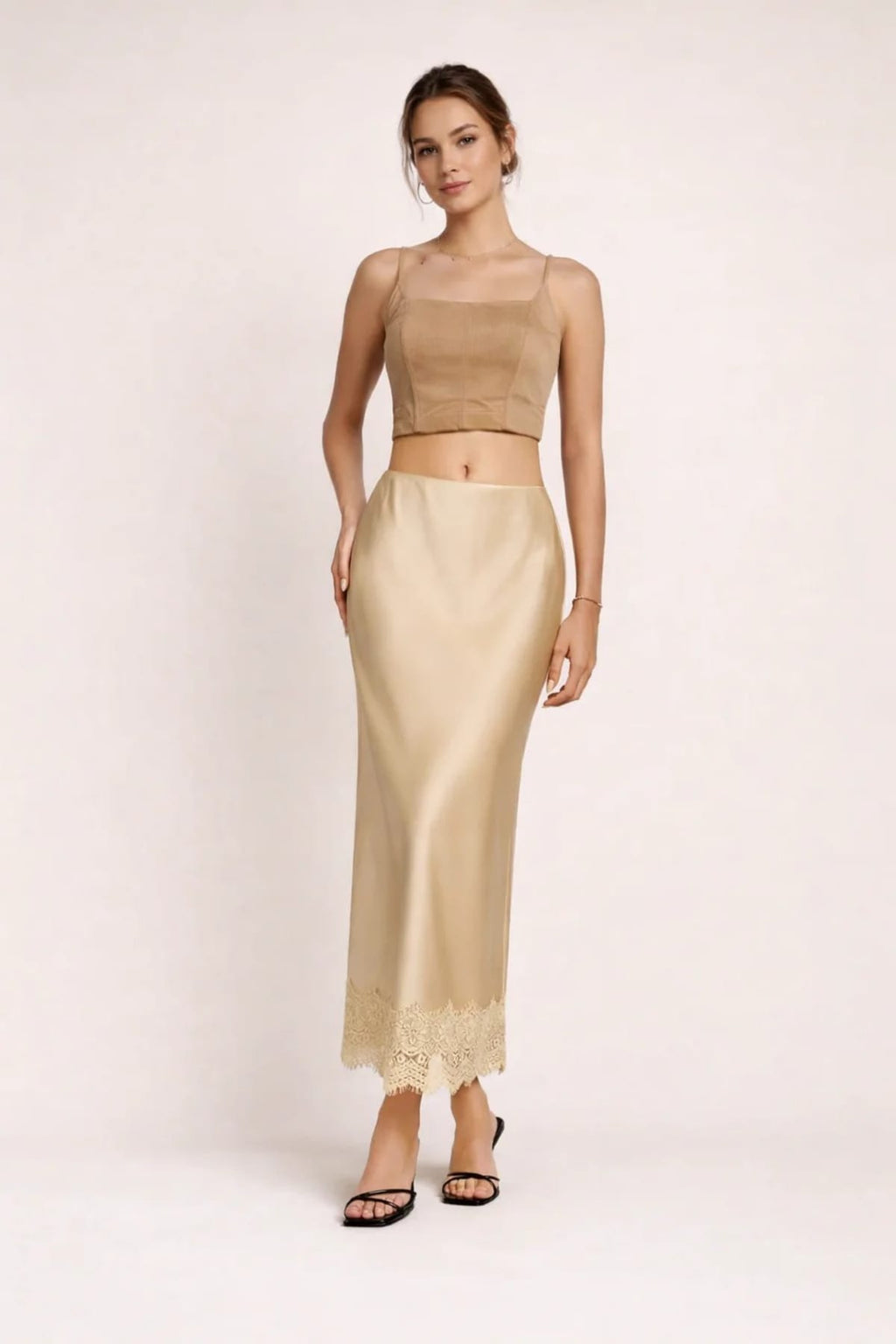Woman modeling a two-piece crop top and maxi skirt set with lace hem.