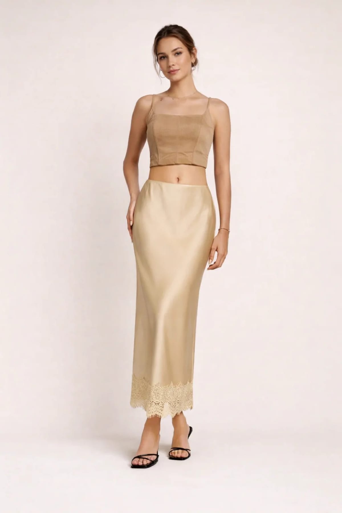 Woman modeling a two-piece crop top and maxi skirt set with lace hem.