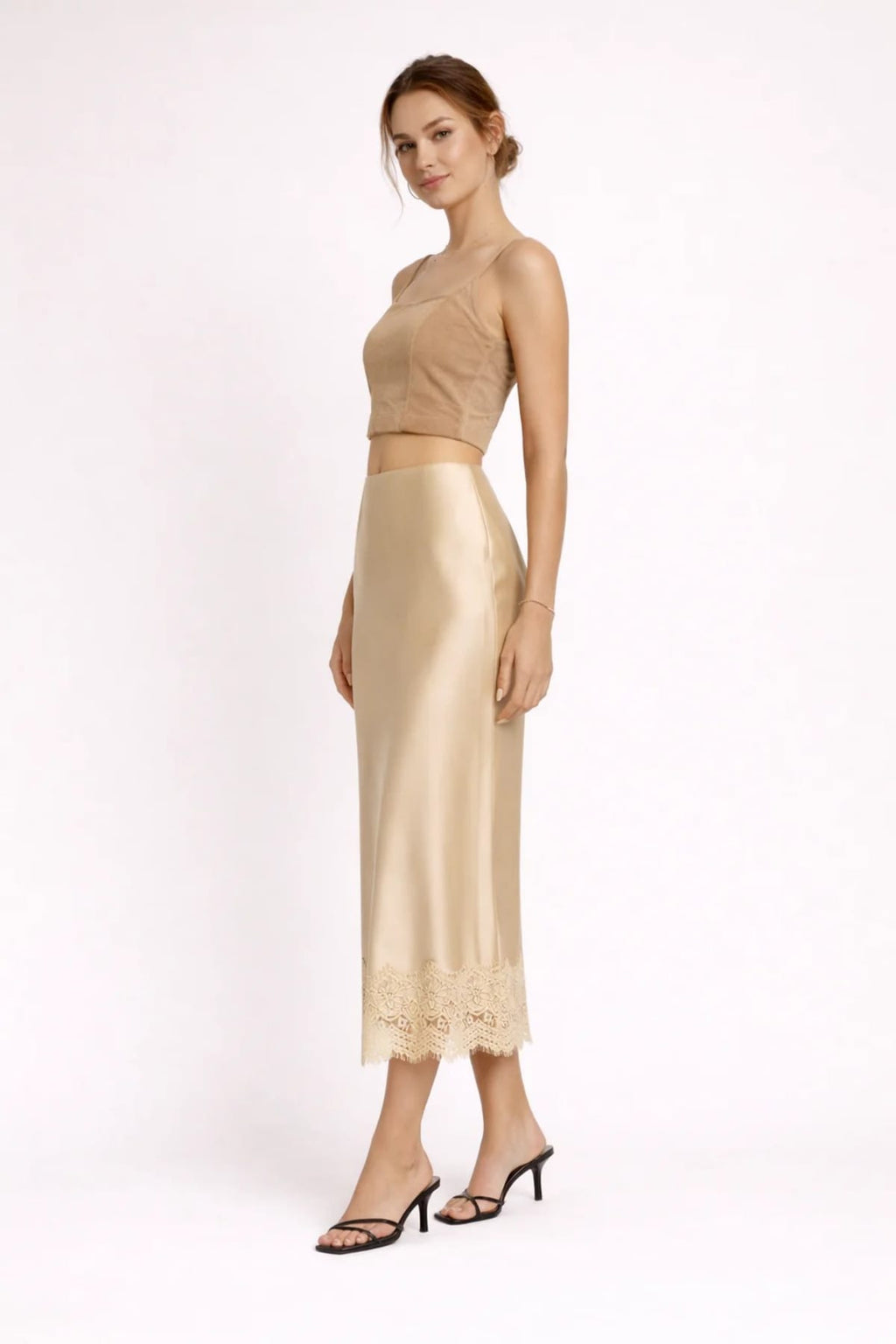 Woman modeling a two-piece crop top and maxi skirt set with lace hem.