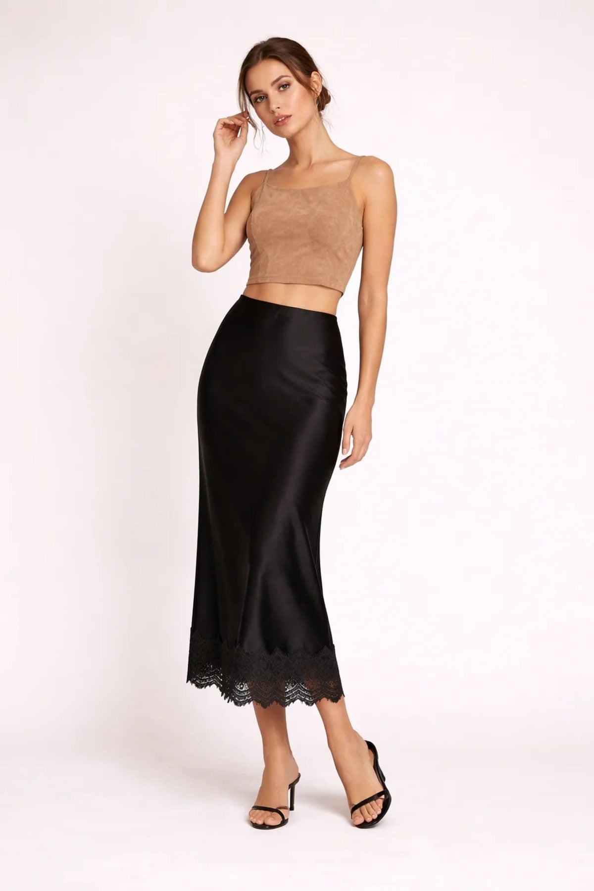 Woman modeling a two-piece crop top and maxi skirt set with lace hem.
