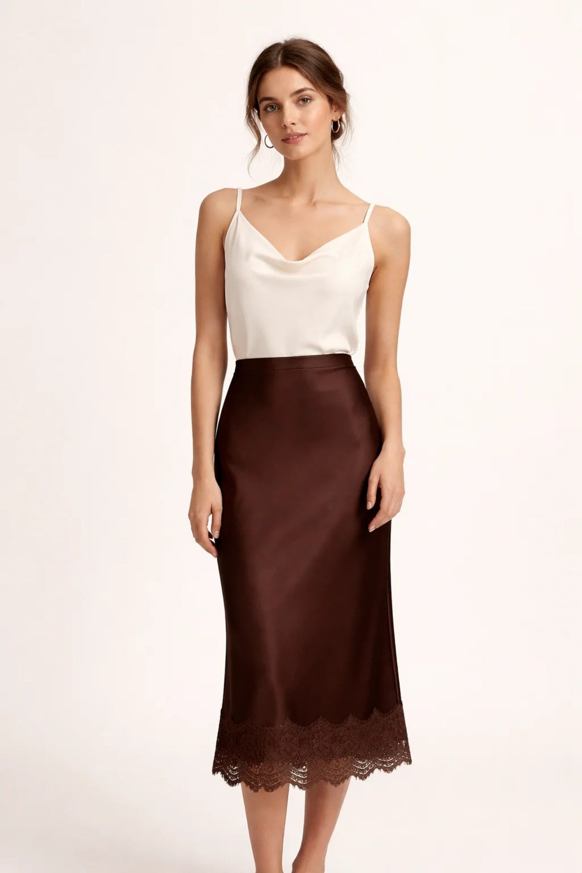 Woman modeling a two-piece crop top and maxi skirt set with lace hem.