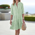 A-line dress with vertical stripes and buttons, lightweight fabric.