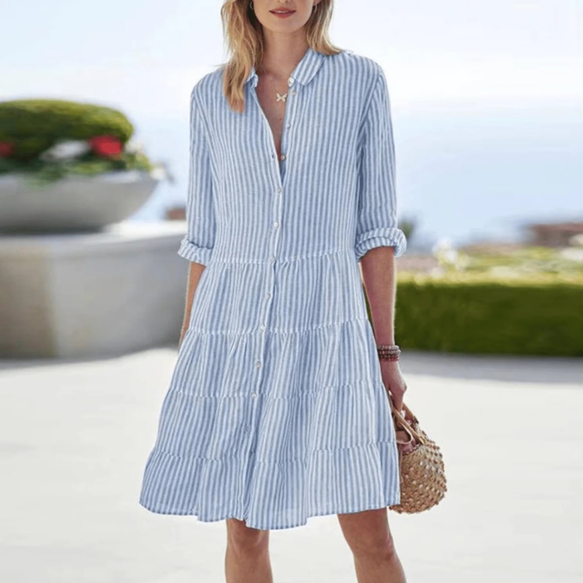 A-line dress with vertical stripes and buttons, lightweight fabric.