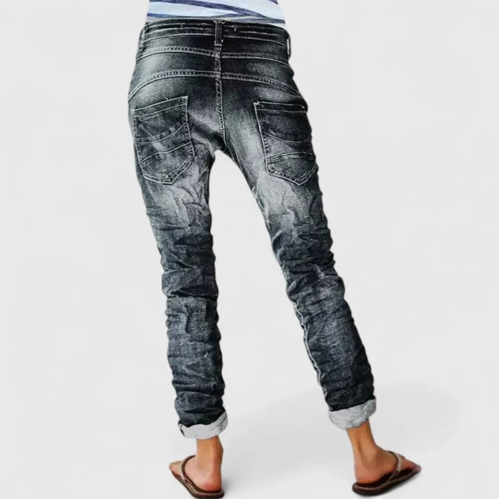 Wide-leg distressed jeans with cuffed hem and mid-rise waist.