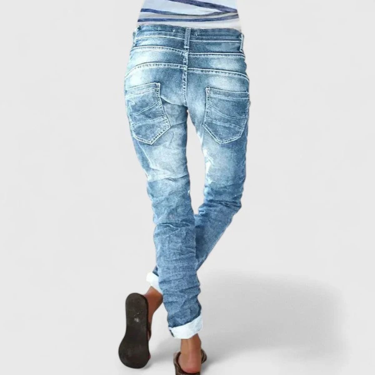 Wide-leg distressed jeans with cuffed hem and mid-rise waist.