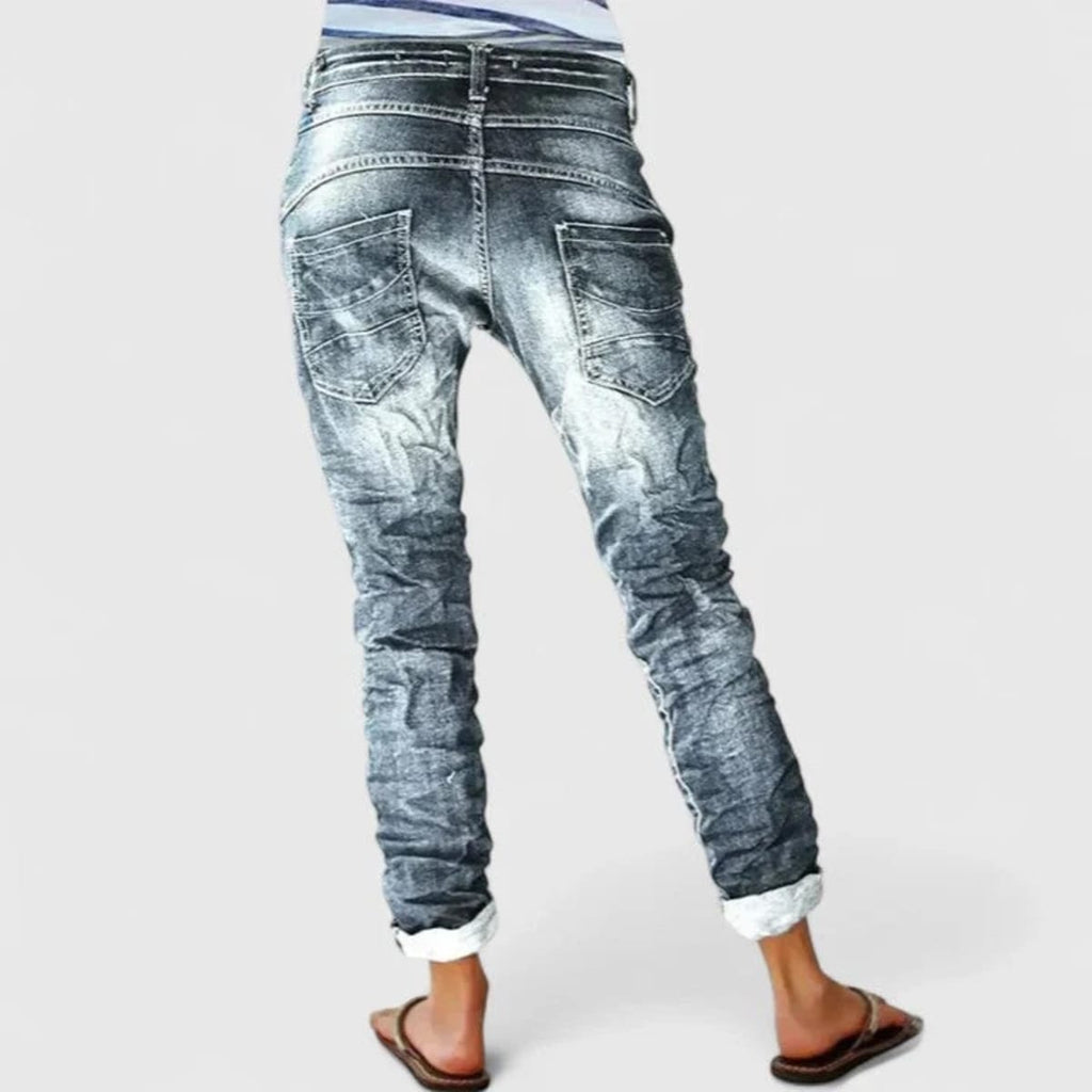 Wide-leg distressed jeans with cuffed hem and mid-rise waist.