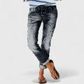 Wide-leg distressed jeans with cuffed hem and mid-rise waist.