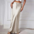 Woman wearing a satin maxi skirt with drawstring waist.