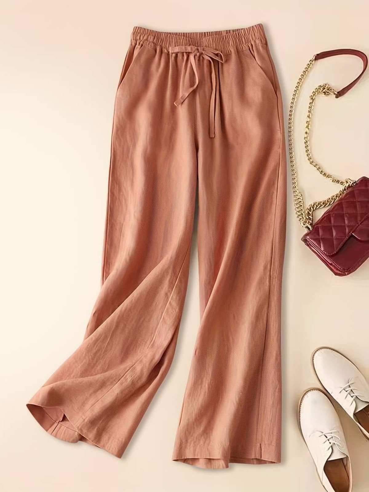 Relaxed drawstring pants with a loose fit and deep pockets.