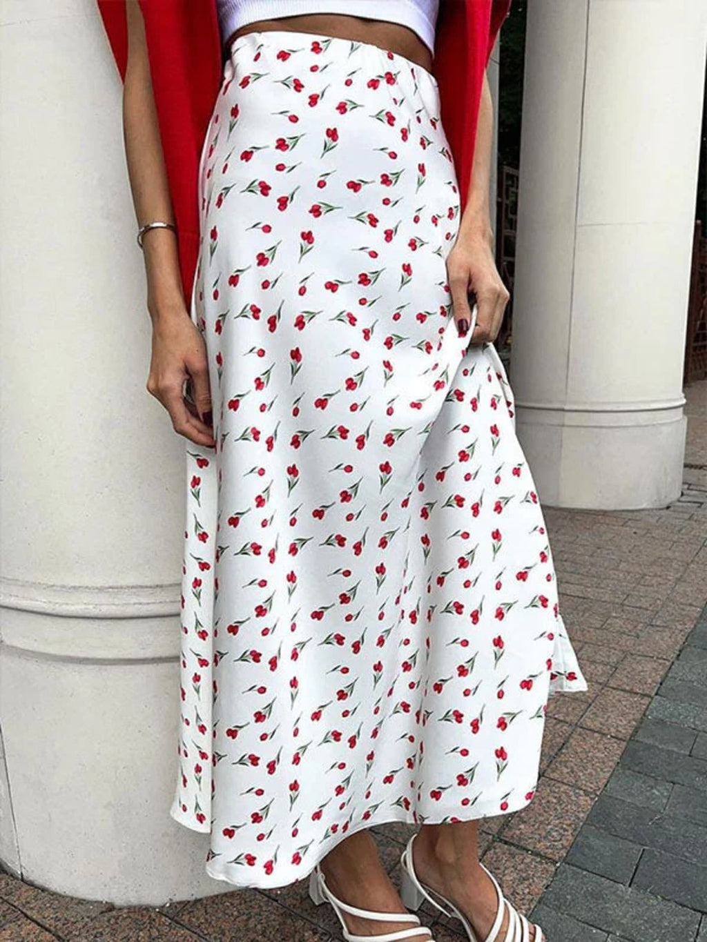 Woman wearing a floral print high-waisted midi skirt with a crop top.