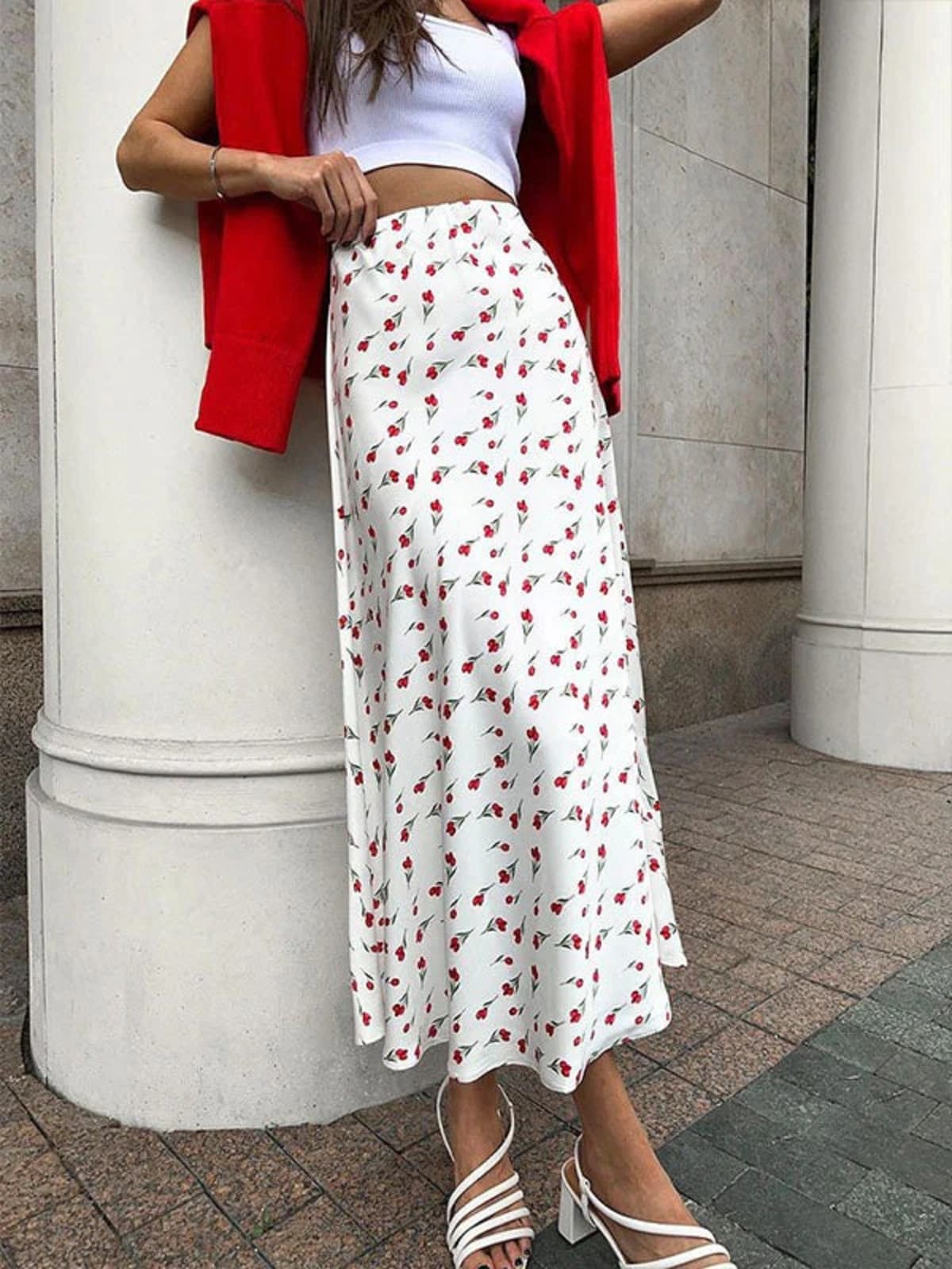 Woman wearing a floral print high-waisted midi skirt with a crop top.