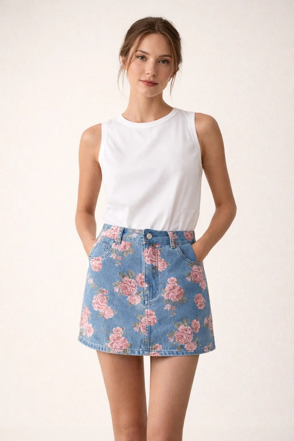Person wearing floral denim mini skirt with pink roses.