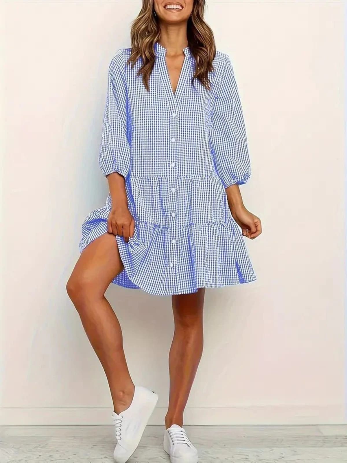 Gingham print mini dress with puff sleeves and ruffle hem.