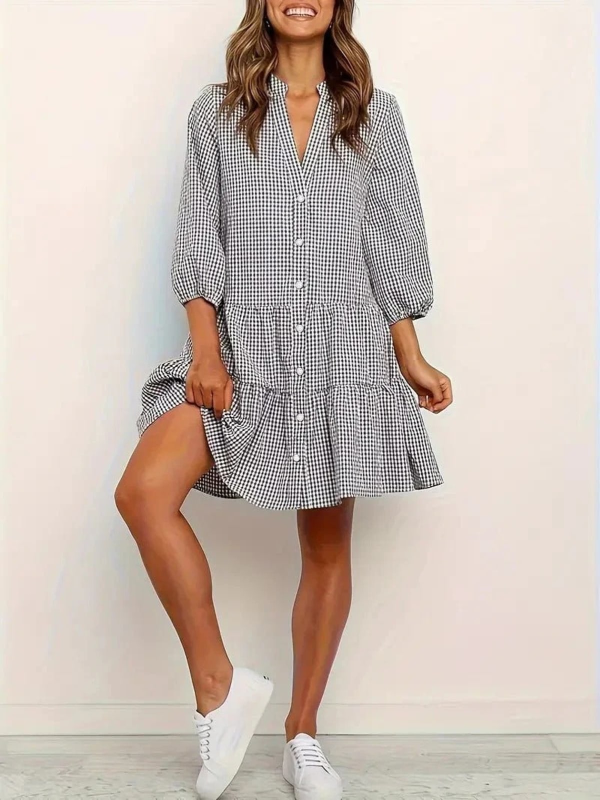 Gingham print mini dress with puff sleeves and ruffle hem.
