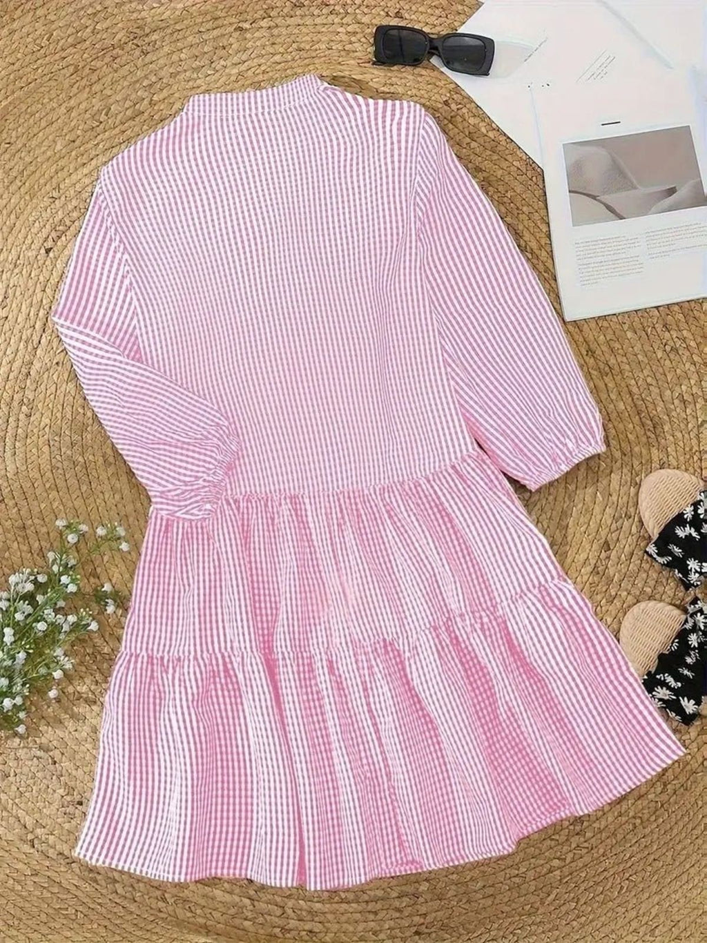 Gingham print mini dress with puff sleeves and ruffle hem.