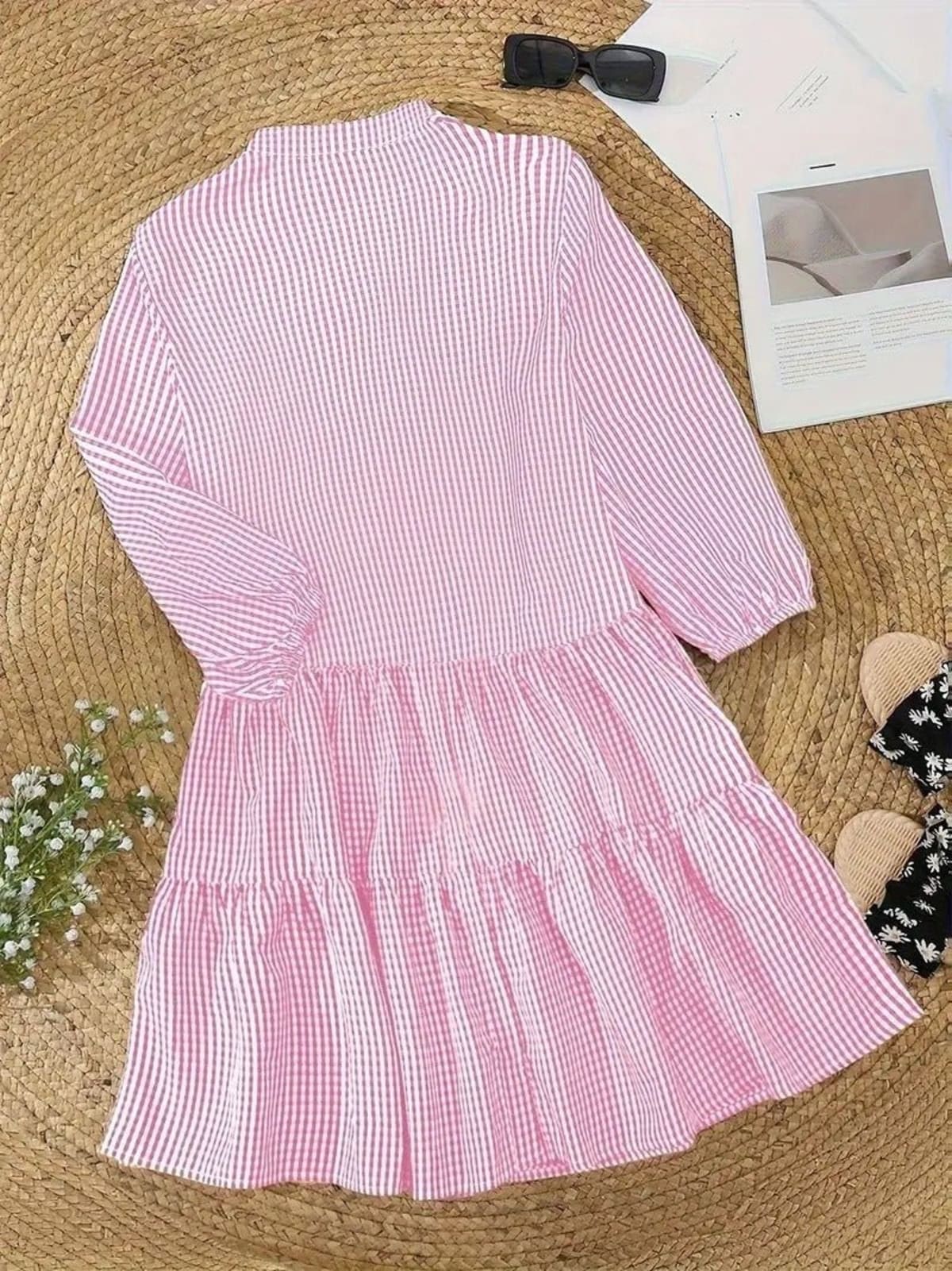 Gingham print mini dress with puff sleeves and ruffle hem.
