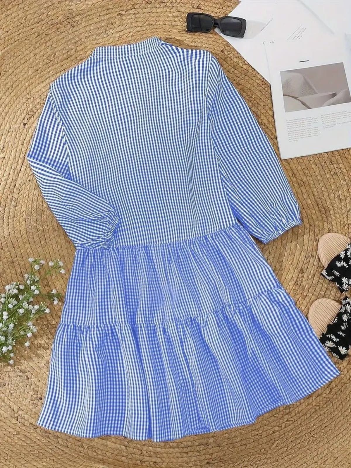 Gingham print mini dress with puff sleeves and ruffle hem.