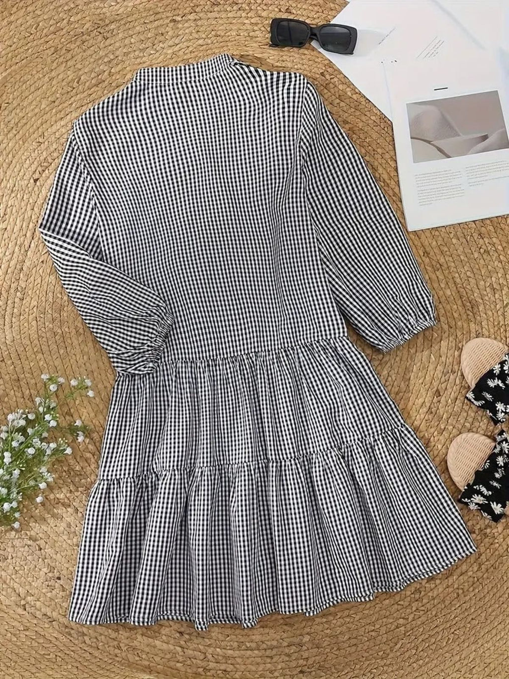 Gingham print mini dress with puff sleeves and ruffle hem.