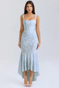 Woman in light blue dress with corset bodice, high-low hem.