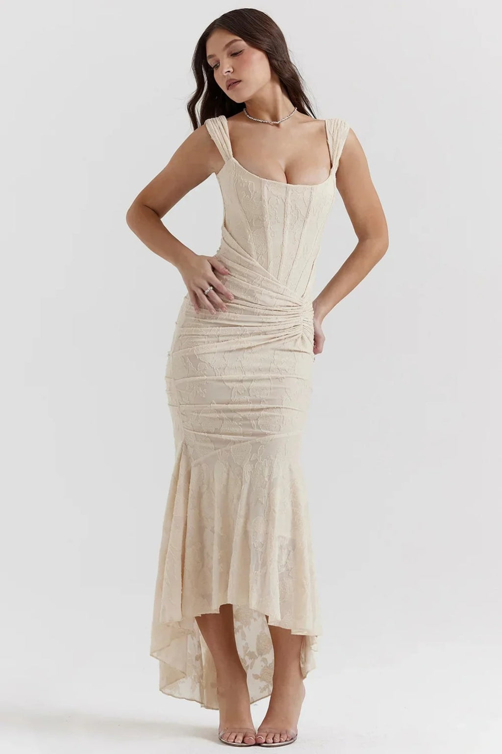 Woman in light blue dress with corset bodice, high-low hem.