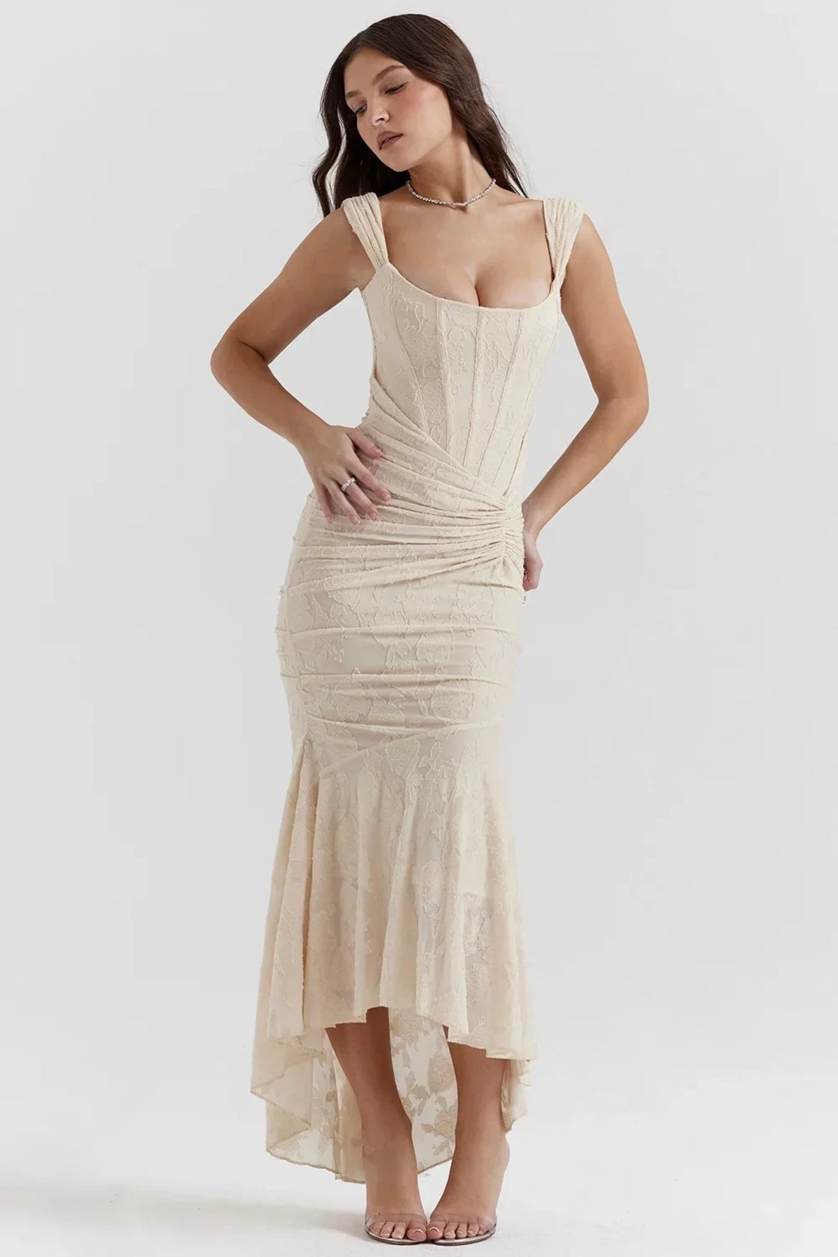 Woman in light blue dress with corset bodice, high-low hem.